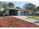 Charming single-story home with a well-manicured lawn, blue paint, and a cozy front porch at 1656 Brentlawn St, Deltona, FL 32725