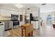 Bright kitchen with stainless steel appliances, white cabinets, and a movable wooden island at 1656 Brentlawn St, Deltona, FL 32725