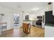 Bright kitchen with white cabinets, stainless steel appliances, and wood floors at 1656 Brentlawn St, Deltona, FL 32725