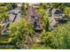 Aerial view of a lakefront community with mature landscaping and custom tile roofs at 1665 Temple Dr, Winter Park, FL 32789