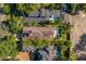 Aerial view showcasing the property's tile roof, private backyard oasis with a pool and lush landscaping at 1665 Temple Dr, Winter Park, FL 32789