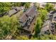 An aerial view shows this two-story home with a tile roof, a private backyard oasis with a pool, and lush landscaping at 1665 Temple Dr, Winter Park, FL 32789