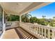 Charming balcony with classic white balustrade railings, tiled floor, and views of the yard at 1665 Temple Dr, Winter Park, FL 32789