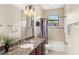 Well-lit bathroom with a granite countertop, dark wood cabinets, and a framed mirror at 1665 Temple Dr, Winter Park, FL 32789