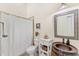 Quaint bathroom with a decorative sink, vanity, and shower with a stylish curtain at 1665 Temple Dr, Winter Park, FL 32789