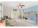 Inviting bedroom with a custom bed frame, chair, ottoman, and access to a balcony with natural light at 1665 Temple Dr, Winter Park, FL 32789