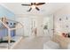 Cozy bedroom with a unique wooden bed frame, light blue accent wall, and ample natural light at 1665 Temple Dr, Winter Park, FL 32789