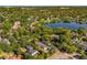 Aerial view of a residential neighborhood with tree-lined streets, a community lake, and a variety of home styles at 1665 Temple Dr, Winter Park, FL 32789