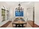 Formal dining room with a large wooden table, hardwood floors, and detailed wall art at 1665 Temple Dr, Winter Park, FL 32789