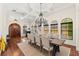 An elegant dining room featuring wood floors, coffered ceilings, and plentiful natural light at 1665 Temple Dr, Winter Park, FL 32789