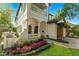 Inviting two-story home featuring manicured landscaping and stone walkway to front door, with a second story balcony at 1665 Temple Dr, Winter Park, FL 32789