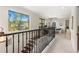 Hallway with view to the outside and a wrought iron banister at 1665 Temple Dr, Winter Park, FL 32789