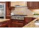 A closer look at the kitchen's stainless steel oven and gas range alongside beautiful granite countertops at 1665 Temple Dr, Winter Park, FL 32789