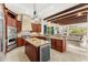 Gourmet kitchen features custom cabinetry, granite countertops, stainless steel appliances, and a center island with a wine cooler at 1665 Temple Dr, Winter Park, FL 32789