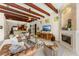 Open-concept living room with high ceilings, wood beams, a fireplace, and seamless flow to the kitchen at 1665 Temple Dr, Winter Park, FL 32789