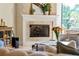 Bright living room with a fireplace and views of the outdoor seating and pool at 1665 Temple Dr, Winter Park, FL 32789