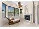 Bright sitting room features a fireplace, chandelier, and large windows with outside views and a chaise lounge at 1665 Temple Dr, Winter Park, FL 32789