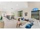 Bright loft featuring a cozy white sofa, neutral walls, and large windows with natural light at 1665 Temple Dr, Winter Park, FL 32789
