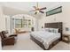 A primary bedroom features a sitting area, fireplace, large windows, and a ceiling fan at 1665 Temple Dr, Winter Park, FL 32789