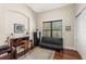 Office features dark wood desk, futon, and large window with view to the outdoors at 1665 Temple Dr, Winter Park, FL 32789