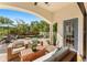 Covered patio area with outdoor seating, overlooking the pool and landscaped backyard at 1665 Temple Dr, Winter Park, FL 32789