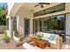 Inviting outdoor patio with wicker furniture, ceiling fans, and seamless access to interior at 1665 Temple Dr, Winter Park, FL 32789