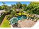 Aerial view of pool, patio with umbrella and outdoor furniture, surrounded by mature landscaping and greenery at 1665 Temple Dr, Winter Park, FL 32789