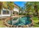 Stunning freeform pool and spa, a lush garden, and a relaxing patio create an outdoor oasis at 1665 Temple Dr, Winter Park, FL 32789
