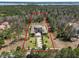Aerial view showcasing the property and outlining the property lines and surrounding trees at 16812 Vinci Way, Bella Collina, FL 34756
