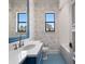 Charming bathroom with bright blue accents, floral wallpaper, and white subway tile at 16812 Vinci Way, Bella Collina, FL 34756