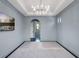Airy bedroom featuring an arched doorway leading to an ensuite bathroom at 16812 Vinci Way, Bella Collina, FL 34756