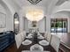 Formal dining room featuring large windows, a modern chandelier, and elegant decor at 16812 Vinci Way, Bella Collina, FL 34756