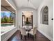 Bright dining area with a modern chandelier, large windows, and backyard pool view at 16812 Vinci Way, Bella Collina, FL 34756