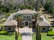 Stunning two-story home featuring a barrel tile roof, stone accents, and meticulous landscaping at 16812 Vinci Way, Bella Collina, FL 34756