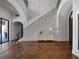 Elegant foyer with high ceilings, grand staircase, herringbone floors, and stylish console table at 16812 Vinci Way, Bella Collina, FL 34756
