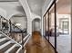Hallway featuring Herringbone floors, arched doorways, and walls of glass overlooking an outdoor kitchen at 16812 Vinci Way, Bella Collina, FL 34756