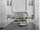 Contemporary kitchen featuring custom cabinets, a large island and modern appliances at 16812 Vinci Way, Bella Collina, FL 34756