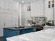 The chef's kitchen features an island, custom cabinets and countertops, and modern appliances at 16812 Vinci Way, Bella Collina, FL 34756