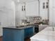 The chef's kitchen features a large island, custom cabinets and countertops, and modern appliances at 16812 Vinci Way, Bella Collina, FL 34756