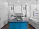 Gourmet kitchen featuring custom cabinetry, a large island with blue accents, and marble countertops at 16812 Vinci Way, Bella Collina, FL 34756