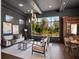 Stylish living room boasting a large window with views of the lush, green landscape at 16812 Vinci Way, Bella Collina, FL 34756