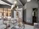 Sophisticated living area featuring a seamless transition to an outdoor patio and a view to a powder room at 16812 Vinci Way, Bella Collina, FL 34756