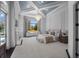 Serene main bedroom with a statement chandelier, fireplace, and scenic views of the outdoors at 16812 Vinci Way, Bella Collina, FL 34756