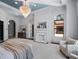 Bright main bedroom features a decorative fireplace, a view to the outside, and an ensuite bathroom at 16812 Vinci Way, Bella Collina, FL 34756