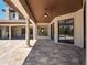 Elegant outdoor space featuring stone columns, travertine flooring, wood-paneled ceiling, and open views of the backyard at 16812 Vinci Way, Bella Collina, FL 34756