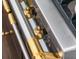 Close-up of a modern gas stovetop with gold knobs and chrome trim at 16812 Vinci Way, Bella Collina, FL 34756