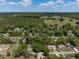 Expansive aerial view of the home's location within a sprawling neighborhood with lush greenery at 1686 17Th St, Orange City, FL 32763