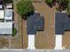 Aerial view of the house showing the dark roof, green grass, and long driveway at 1686 17Th St, Orange City, FL 32763