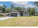 Attractive single-story home with a gray exterior, well-kept lawn, and a two-car attached garage at 1686 17Th St, Orange City, FL 32763