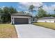 Charming gray single-story home with a two-car garage and a long driveway leading to the street at 1686 17Th St, Orange City, FL 32763